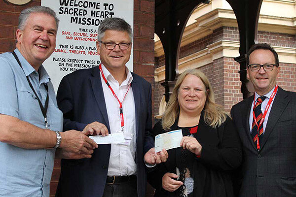 greg-barns-donation Cathy Humphrey and Father John accepting a donation from Greg Barns