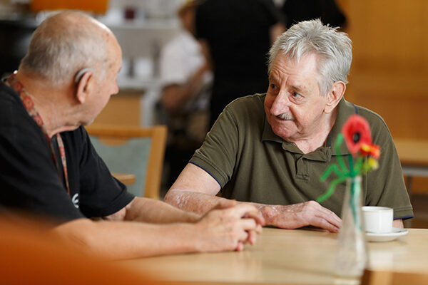 sacred-heart-community-residents Two Sacred Heart Community residents having a chat