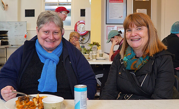 Bethlehem-community-manager-christine-with-client Bethlehem Community Manager Christine with client sitting in the Dining Hall