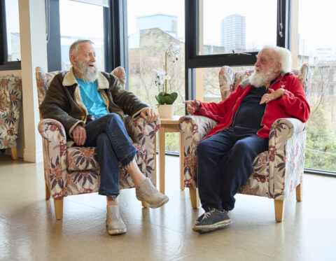 Two older gentlemen sitting together