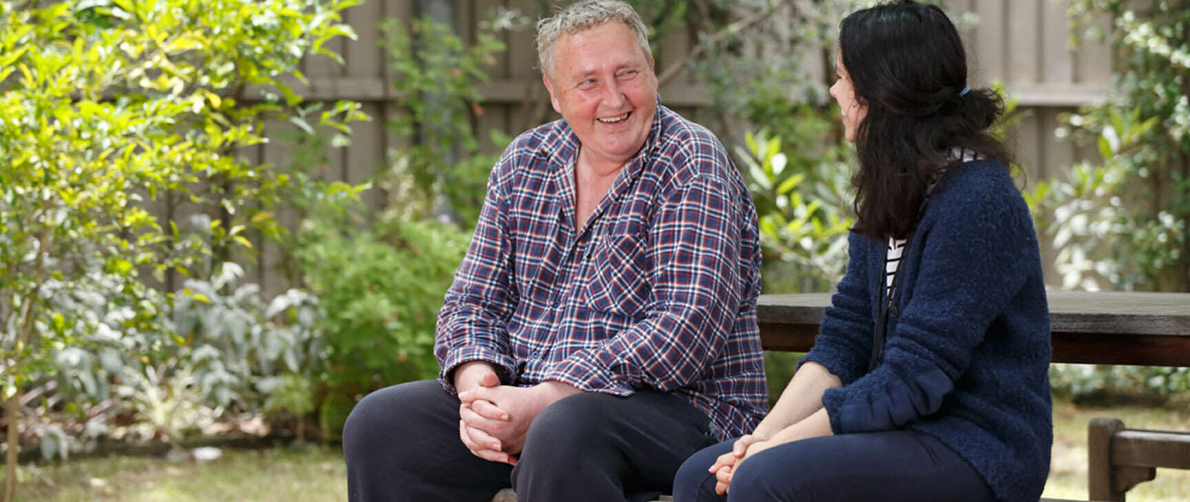 Client and case manager having a conversation while sitting outside