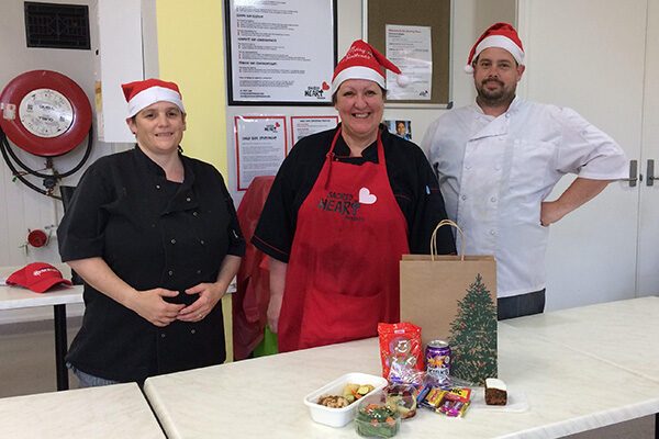 dining-hall-team-presents-christmas-lunch Three members of our Dining Hall team presenting our takeaway Christmas Day lunch