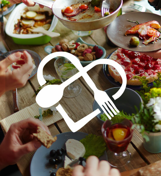 Dine With Heart logo. In the background is a dinner table with several dishes.