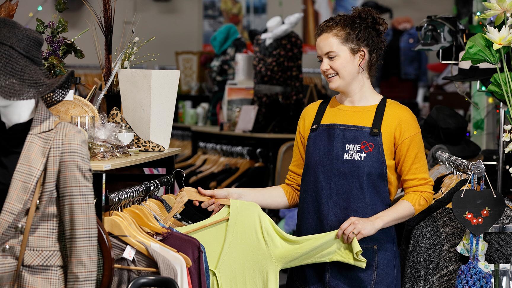Op shop volunteer organising clothes in one of our stores