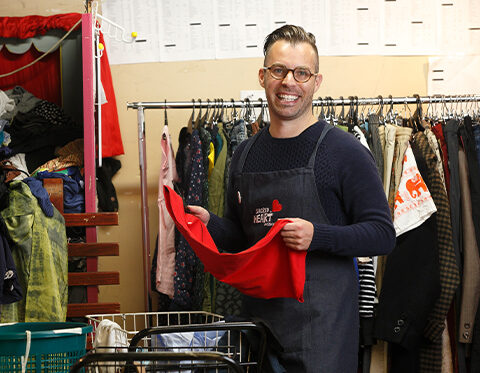 Op shop team member sorting clothes