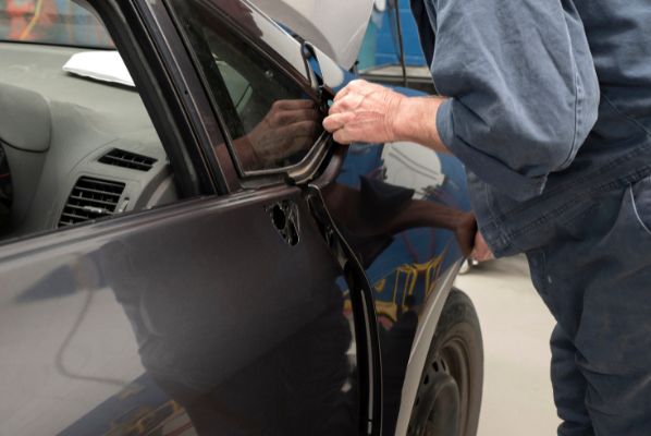 J2SI participant repairing a car