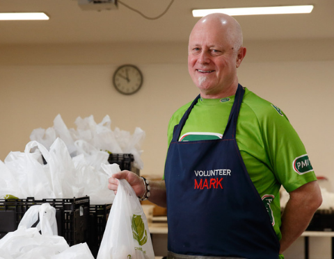 Mark a volunteer holds a meal takeaway bag