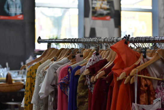 Clothes rack full of colourful designer clothes