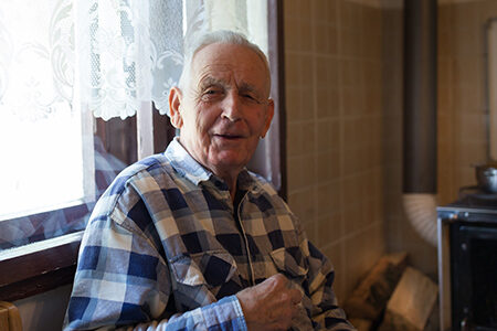 Elderly man sitting in his kitchen
