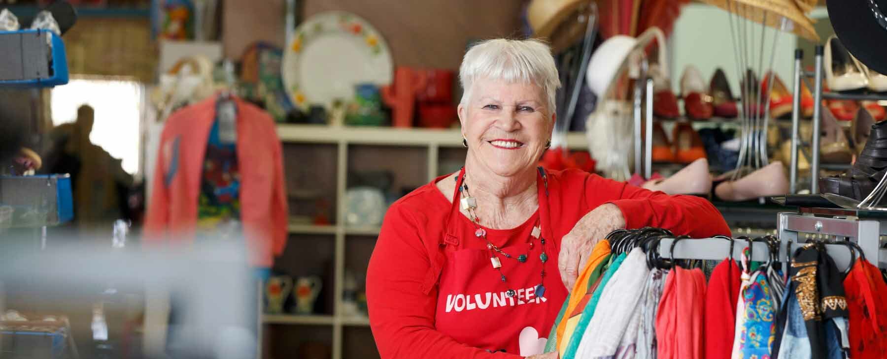 Op shop volunteer smiling into the camera