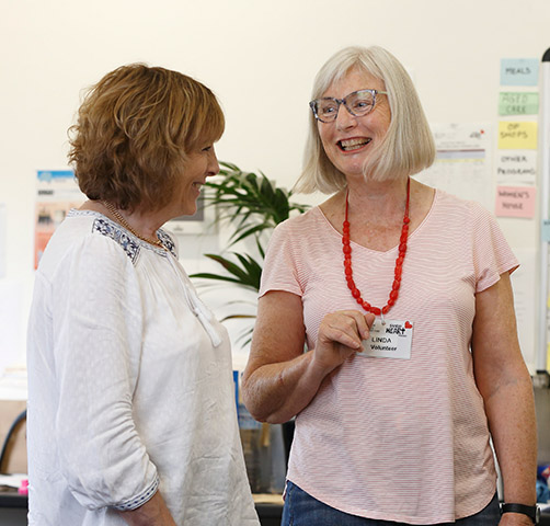Two women standing in an office and talking
