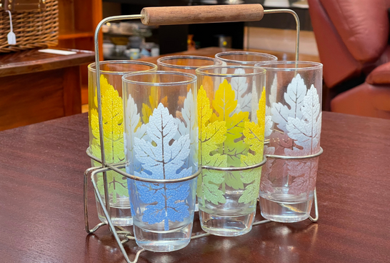 A wire tray holding vintage glasses