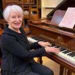 Trish Williams, op shop coordinator, playing the piano