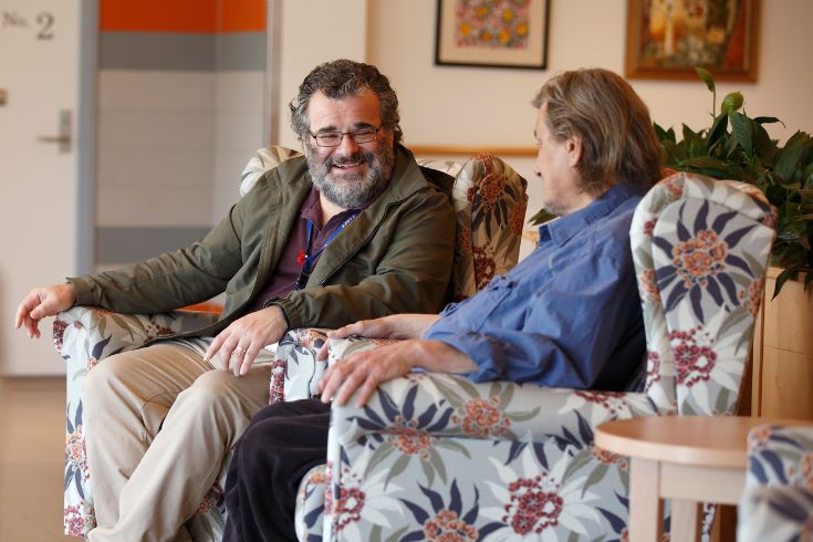 two-men-talking Two men sitting in armchairs and talking with each other