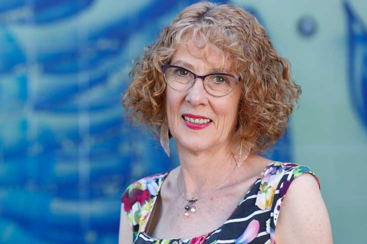 sue-worland Donor Relations Coordinator Sue Worland standing in front of a colourful wall