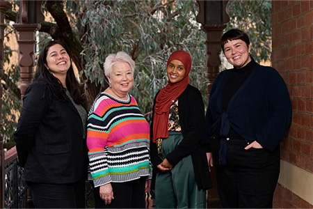 four friendly women smiling at the camera