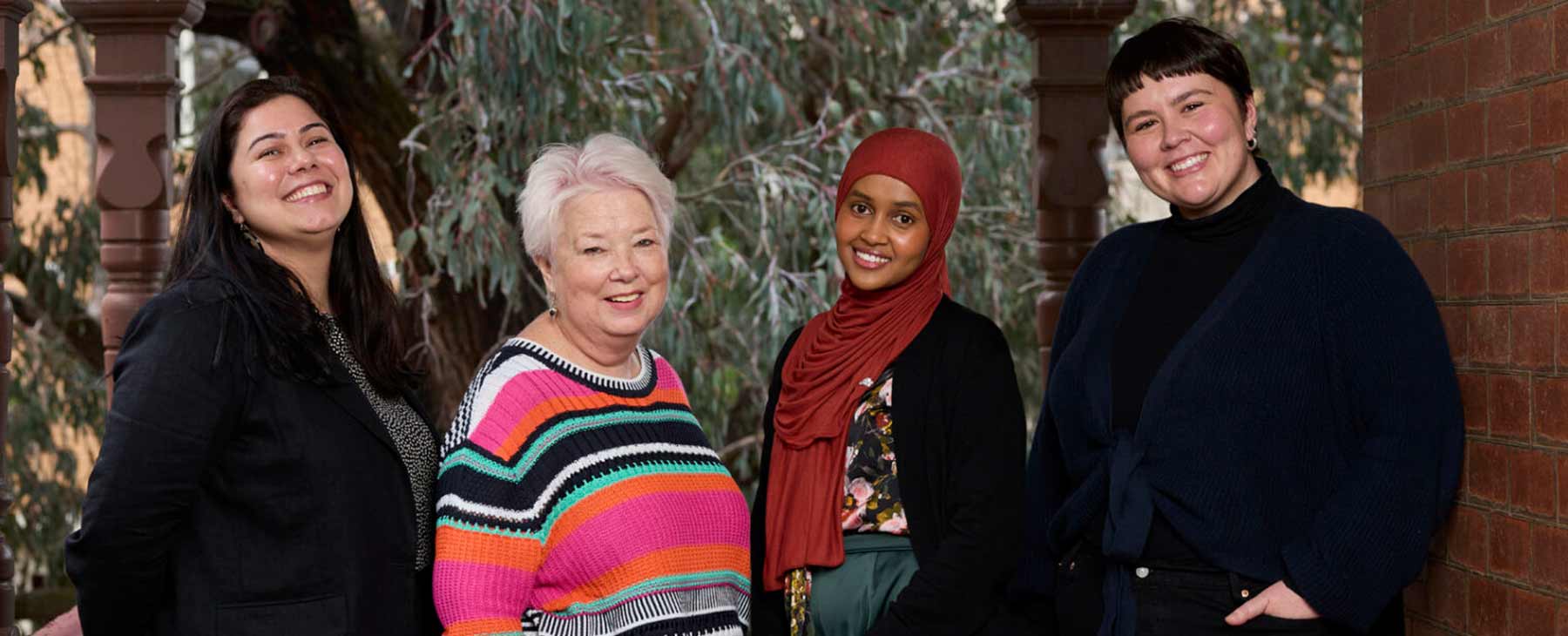 four friendly women smiling at the camera