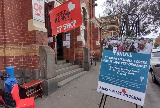 a sign advertising the SKULL performances sit outside a building on the pavement