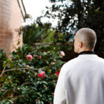 Tyson stands with his back to the camera looking upwards