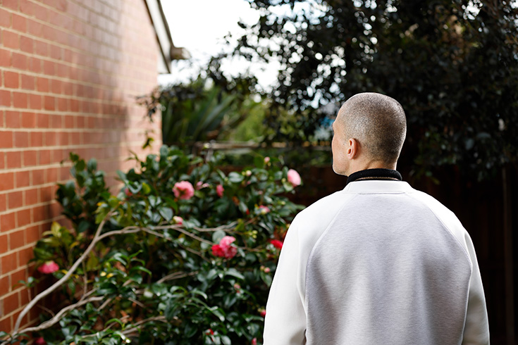 Tyson stands with his back to the camera looking upwards