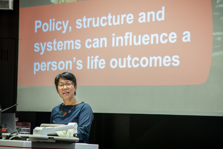 Hang Vo delivering an oration at the launch of the RMIT Social Equity Research Centre. On a slide behind her, the words 