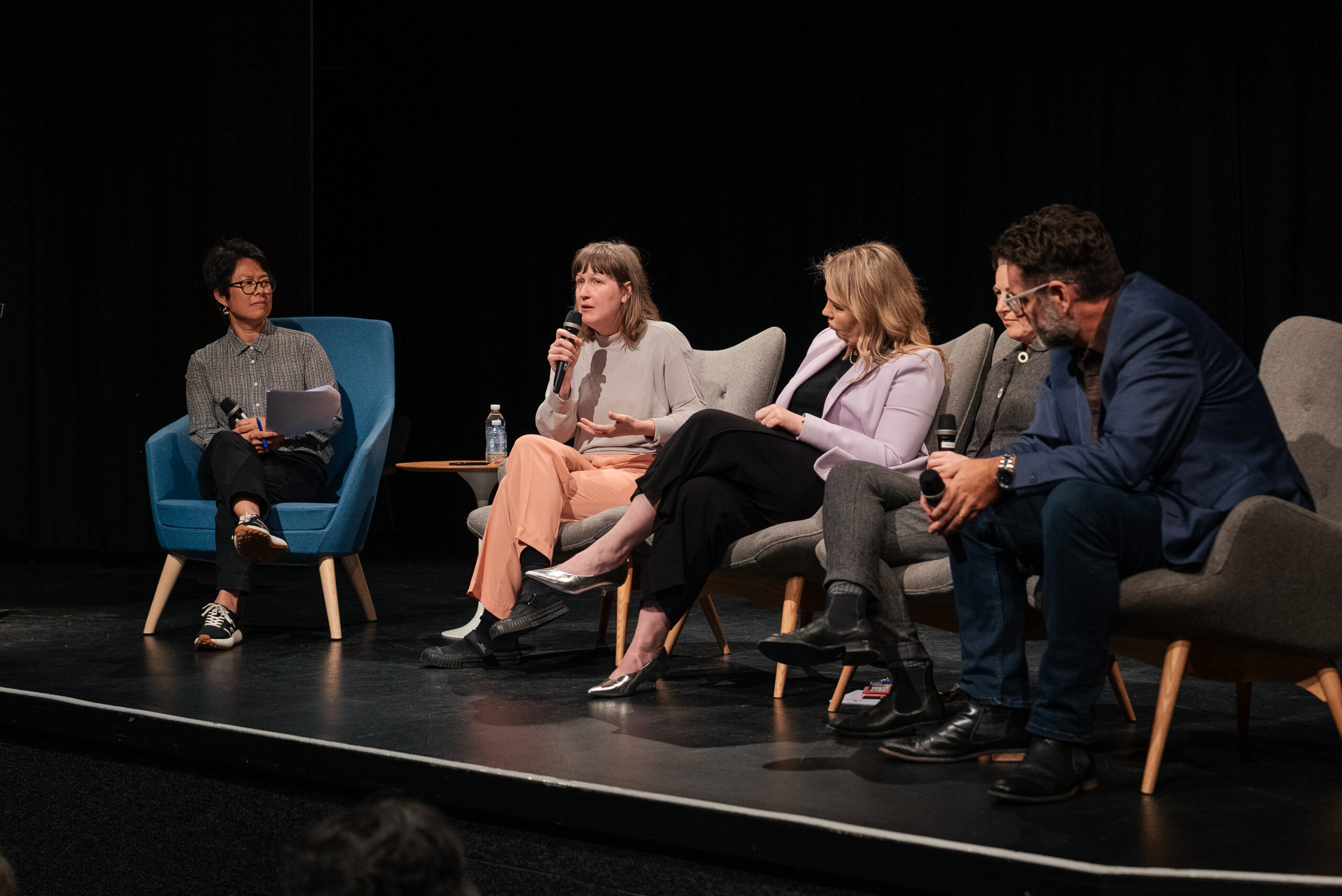Panellists sitting in chairs for a discussion.