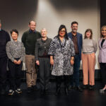 A group of people standing on a stage.