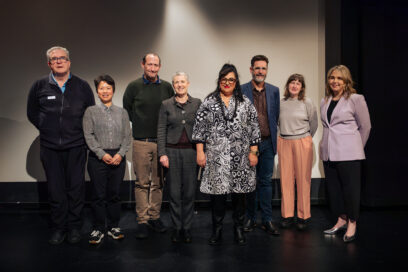 A group of people standing on a stage.