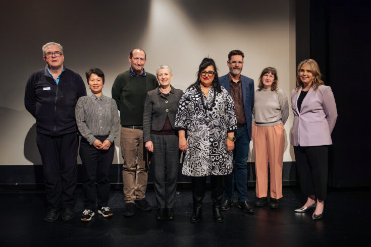 A group of people standing on a stage.
